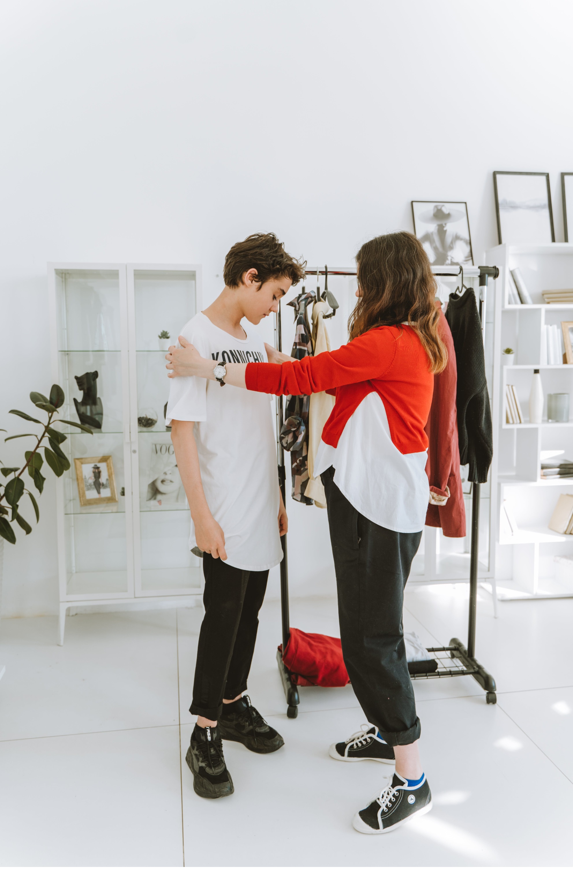 A mother helps her child try on clothing to see if it is suitable for his sensory needs