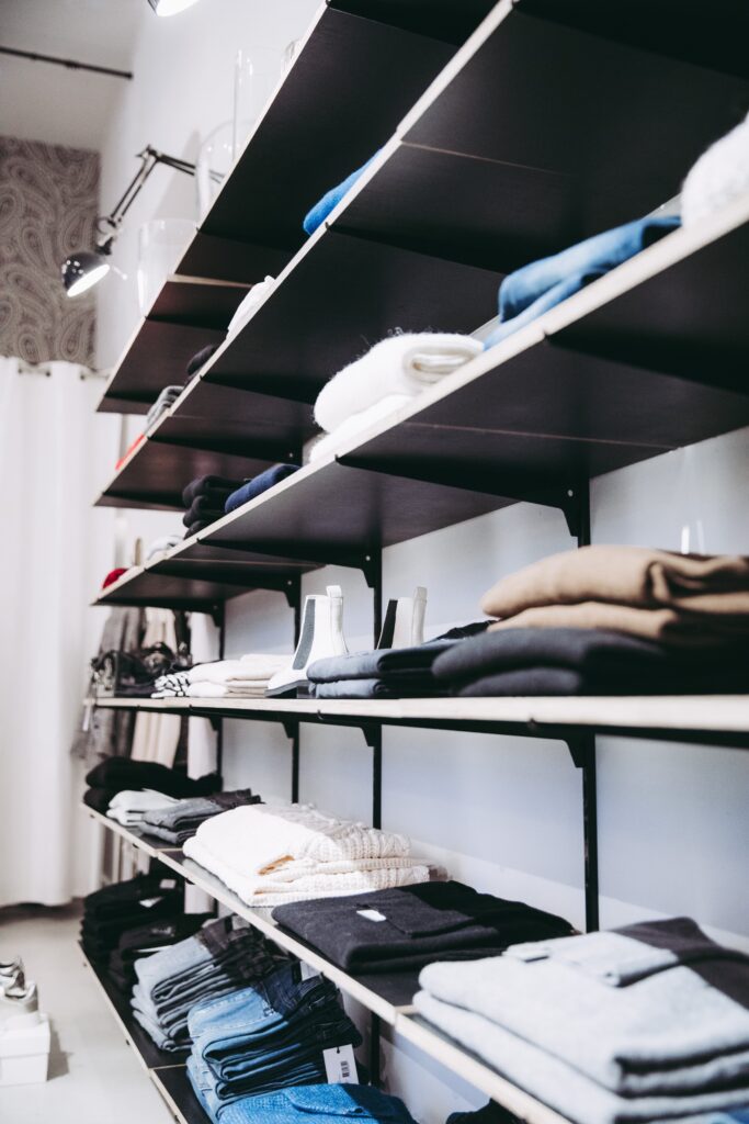 A selection of various clothes sitting on shelves